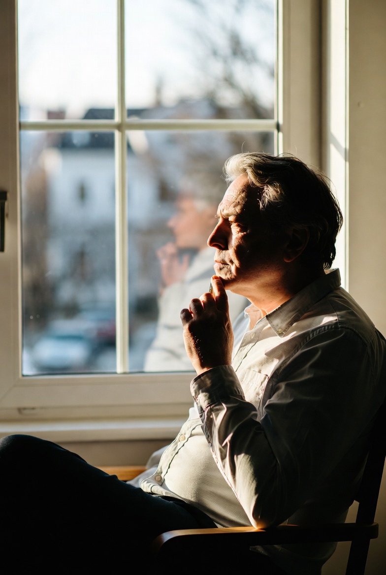 Couple reviewing long-term care insurance documents with an approval timeline in the background.